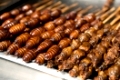 Grill and fried silkworm pupae on stick from Wangfujing street at Beijing, China